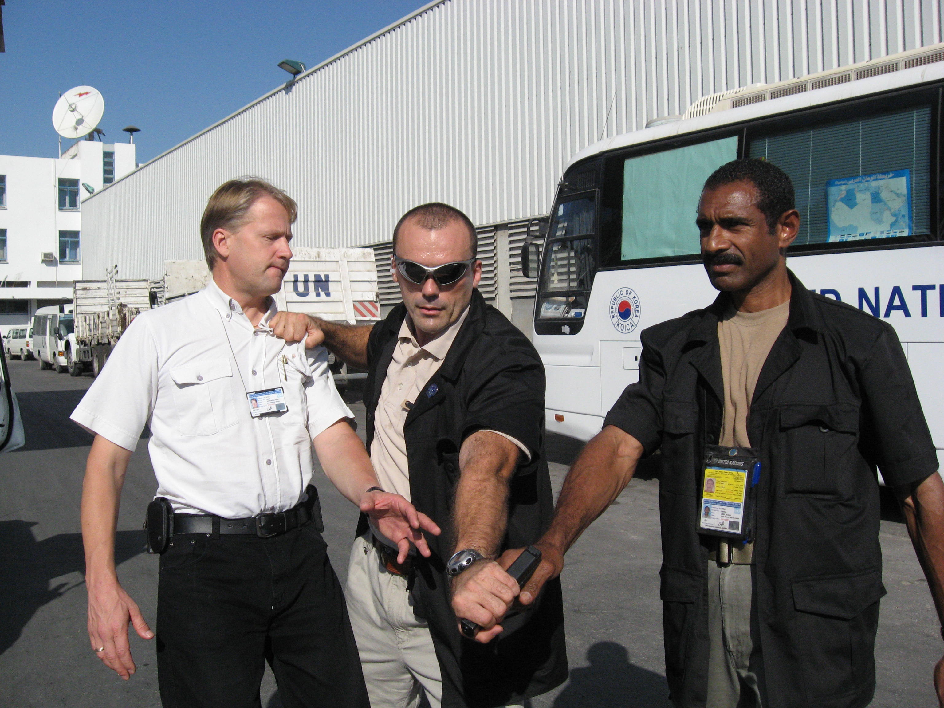 Close-protection demonstration beside United Nations vehicles